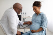 © Prostock-studio - Male experienced doctor examining young pregnant woman