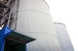 © Surachetsh - Silo Metal Sheet container settles on the ground with white background.