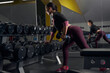 © Svitlana - Young sporty female person lifting heavy weights