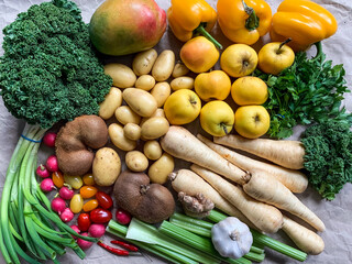 Healthy eating: grocery shopping or delivery of fresh fruits and vegetables. Rich vitamin vegetables. Variety of fruits and vegetables on craft paper. Fresh potatoes parsnips carrots apples kiwi peppe