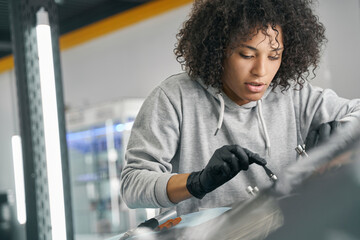 Canvas Print - Focused worker mounting automotive equipment on windscreen