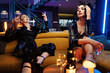 © konradbak - Two young attractive ladies having fun at the party