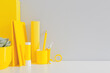 © mallmo - Desk with yellow office supplies. Creative workspace and grey wall. Stylish home office.