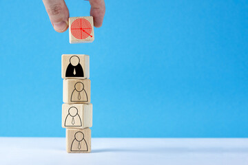 Wooden cubes with target arrow and group of people.