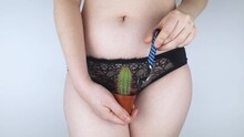 The Girl Holds A Cactus In Front Of Her Pubis. Symbol Of Stubble And Problems With Home Depilation. Razor Near Excess Hair. Body Positivity And Body Hair Problems.