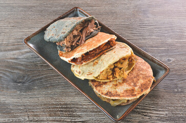 Poster - A closeup shot of pitas with meat and different souses on the wooden table