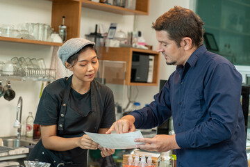 Male businessman is a customer coming to a restaurant where the counter orders coffee and the barita offers drink recommendations in cafes and restaurants.