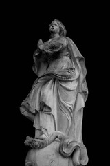  Religious symbol of Christianity: Virgin Mary stands foot on the snake as a symbol of the victory of good over evil. Selective focus on eyes of an ancient statue.