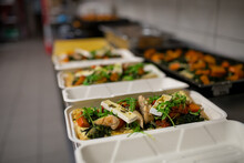 Meals In Containers Prepared For Take Away In Kitchen Restaurant.