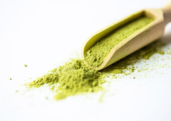 Superfood green powder in a small wooden scoop on white background. Matcha tea powder, spinach, chlorella, moringa, wheatgrass, or broccoli powder. Free space for text or design.