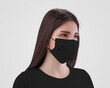 © olegphotor - Mockup of a black surgical mask with ear loops, on a nurse in a sweatshirt, isolated on background, side view.