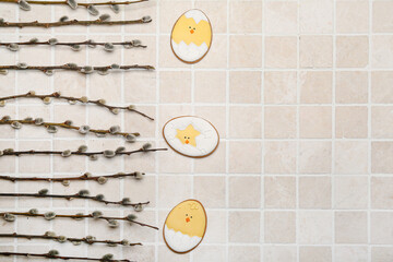 Wall Mural - Willow branches and Easter cookies on light tile background