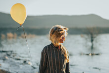 Lady In Fox Fur Hat With Balloon In Nature