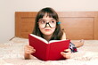 © gmstockstudio - Little girl reading a book at home