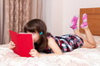 © gmstockstudio - Little girl reading a book at home