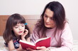 © gmstockstudio - Mom with the daughter reading together