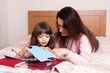© gmstockstudio - Mom with the daughter reading together