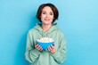 © deagreez - Photo of sweet young bob hairdo lady hold food wear hoodie isolated on blue color background