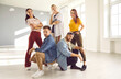 © Studio Romantic - Team of young people posing in dancing studio. Modern dance crew members in informal outfits. Indoor group portrait of talented contemporary, hip hop and break dance instructors, coaches and experts