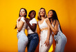 © iordani - diverse multi nation girls group, teenage friends company cheerful having fun, happy smiling, cute posing on yellow background, lifestyle people concept, african-american, asian and caucasian