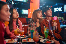 Group Of Asian Guys And Girls Singing Songs At Karaoke Club