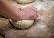© ADDICTIVE STOCK - Unrecognizable baker kneading dough in bakery