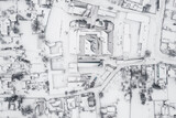 Fototapeta Młodzieżowe - Snow-covered village, view from above. houses covered with snow, severe northern frosts