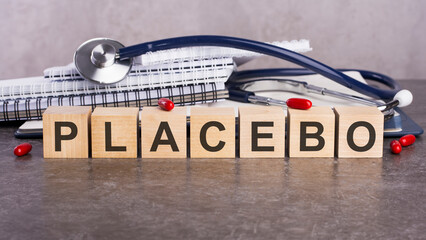 Poster - PLACEBO text on wooden blocks, medical concept, gray background