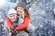 © BillionPhotos.com - Photo of pretty adorable girlfriend boyfriend smiling cuddling riding back walking snow outdoors forest