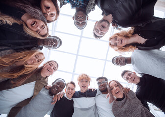 Wall Mural - close up . group of cheerful young people standing in a circle