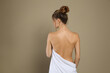 © New Africa - Back view of woman with perfect smooth skin on beige background. Beauty and body care