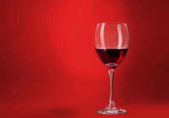 Poster - Red wine glass over colored background on the desk