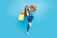 Photo Of Crazy Funny Little Lady Hold Retail Bags Rejoice Wear Green Top Jeans Shoes Isolated Blue Color Background