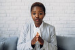© Strelciuc - African businesswoman sitting indoors looking at camera talking with corporate client make video call. Business woman. Business meeting. Conference call. Job
