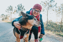 Old Woman With His Dog During A Walk Portrait Wearing A Hat For Spring And Winter Smiling Toc Amera. Senior People Mental Health Activities Outdoors, Active Lifestyle On Third Age. Happy Grandma