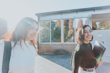 Two woman colleges rushing to get in time to class study at the university college. Learning with friends new at the campus. Fraternity sorority concept