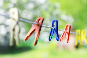 Wall Mural - Clothespins on a clothesline in summer. Dry clothes outside. Clothes on a rope.