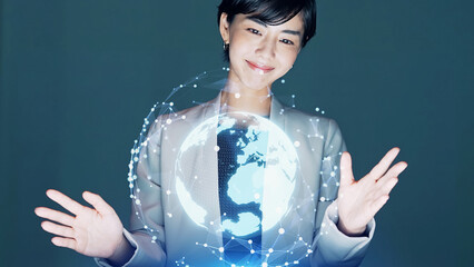 Aufkleber - Asian woman watching hologram of the earth in dark office. Global network.