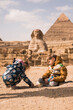 kids plaing on background of Great Sphinx and Chephren's pyramid in Giza, Egypt