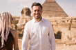 Young Couple in front of the Great Pyramids of Giza, Egypt
