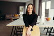 © contrastwerkstatt - Portrait of smiling woman sitting on chair at home office