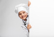 © Syda Productions - cooking, culinary and profession concept - happy smiling little girl in chef's toque and jacket with white board over grey background