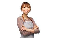 Cooking, Culinary And People Concept - Happy Smiling Female Chef Or Waitress In Apron With Crossed Arms Over White Background