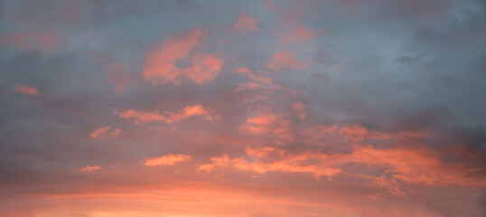 Wall Mural - dreamy sunset scenery, grey and blue sky with pink lighted clouds