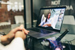 © Jacob Lund - Anonymous businesswoman attending a virtual meeting in a modern office