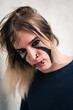 © Robert Petrovic - Tight headshot of an attractive emo punk young man with long hair looking directly in camera. Close up of a pierced and face painted guy in  his late 20s posing in a seductive way.