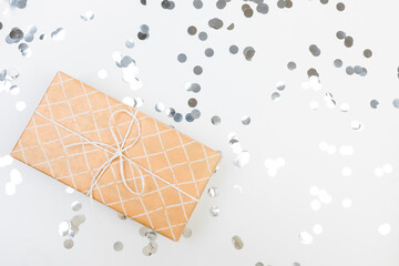 Wall Mural - gifts or presents boxes silver confetti on white table top view. Flat lay composition for birthday, christmas or wedding. - Image