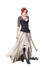 Wall Mural - full length portrait of girl with red hair wearing black corset , torn gothic fantasy gown and leather boots. standing pose, isolated on white studio background.