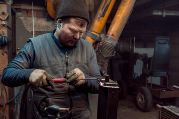 Canvas Print - Welder solders copper car radiator with gas torch