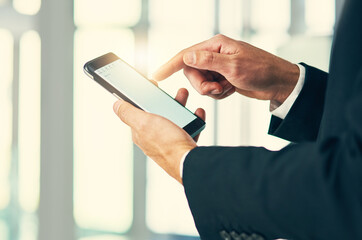 Poster - Engaging with clients in mobile form. Cropped shot of corporate businessmen texting on a cellphone.